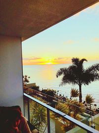 Man looking at swimming pool against sky during sunset