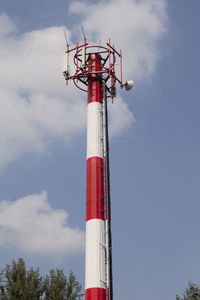 Low angle view of communications tower against sky