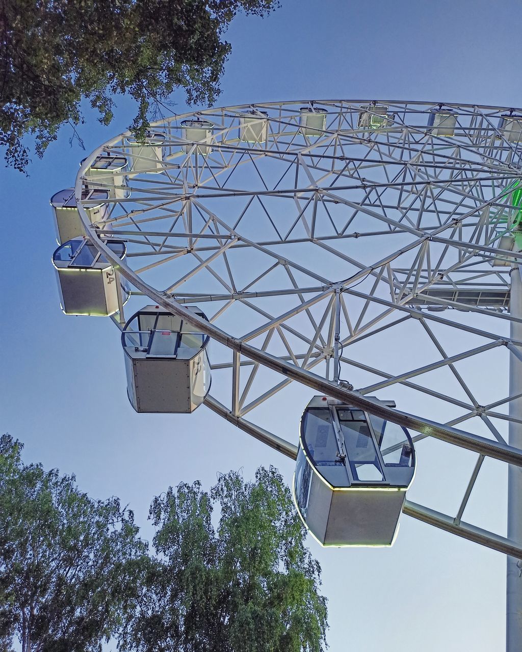 LOW ANGLE VIEW OF FERRIS WHEEL AGAINST BLUE SKY