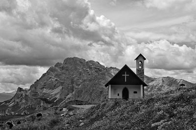 House amidst buildings against sky