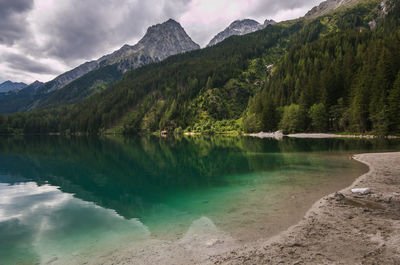 Scenic view of lake and mountains against sky