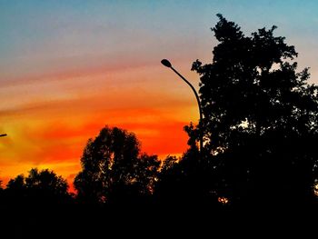 Low angle view of silhouette trees against sky at sunset