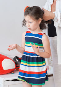 Pretty girl trying on summer outfits with grandmother