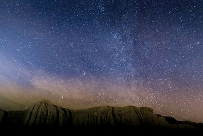 Scenic view of mountains against sky at night