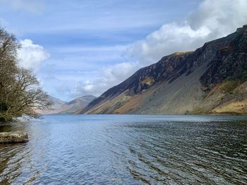 Scenic view of lake and mountains against sky