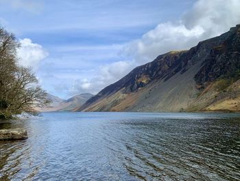 Scenic view of lake and mountains against sky