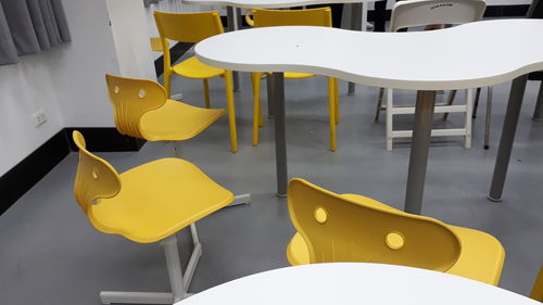 High angle view of empty chairs and table in restaurant