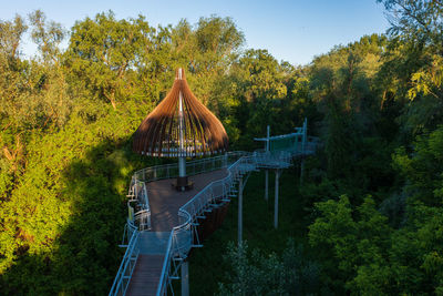 Bridge amidst trees against sky during autumn