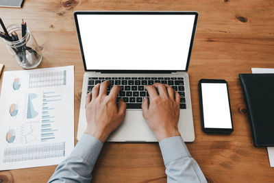 High angle view of man using laptop on table