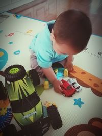 High angle view of boy playing with toy at home