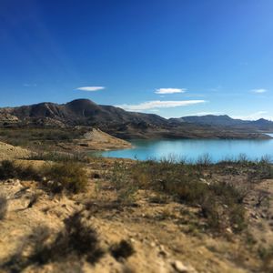 Scenic view of landscape against blue sky
