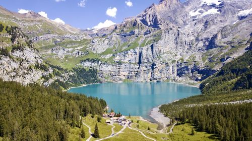 Scenic view of lake by mountains against sky