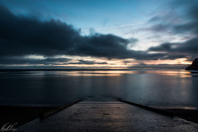 Scenic view of sea against storm clouds