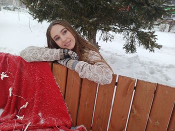 Portrait of smiling woman in snow