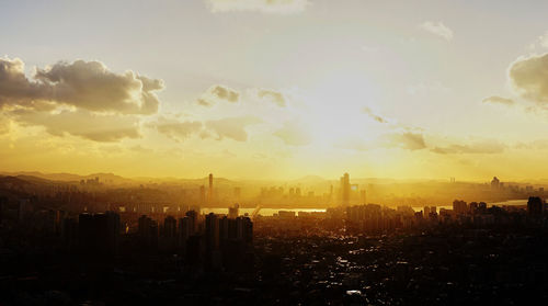 Panoramic view of buildings against sky during sunset