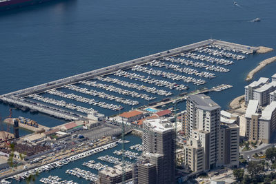 High angle view of buildings by sea in city