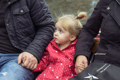 Baby girl sitting in hands