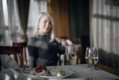 Woman sitting on table at restaurant