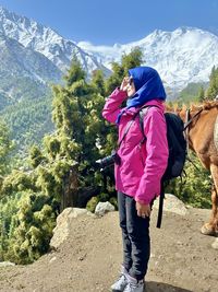 Rear view of woman standing on mountain