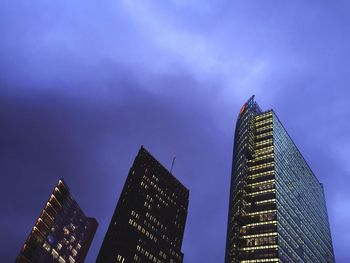 Low angle view of modern building against blue sky