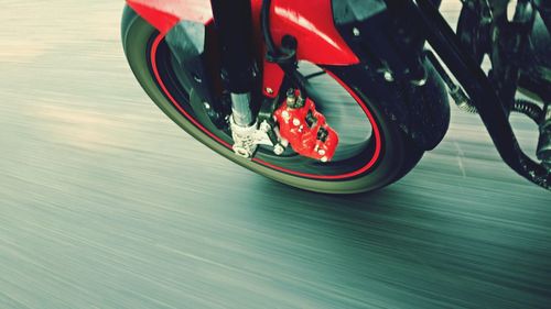 High angle view of motorcycle wheel moving on street