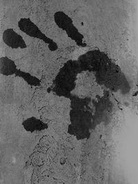 Shadow of hand on sand