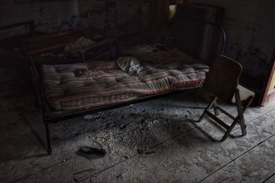 Abandoned chair on bed at home