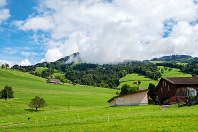 Houses on field against sky