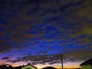 Low angle view of silhouette trees against sky at sunset