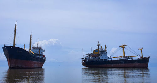 Boats in sea against sky