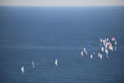 People on sea shore against sky