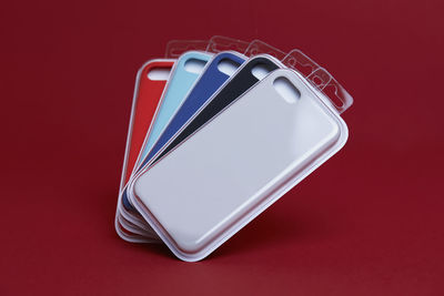 High angle view of smart phone against red background