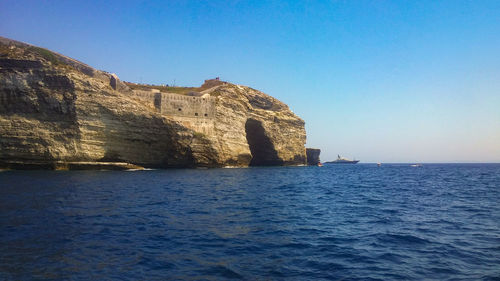 Scenic view of sea against clear blue sky