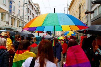 People on street during pride parade in city