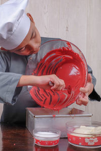 Boy preparing food on table at home