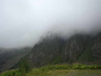 Scenic view of landscape against sky during foggy weather