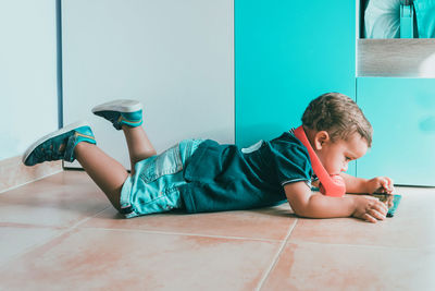 Boy lying on floor at home