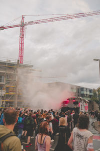 Group of people in city against sky