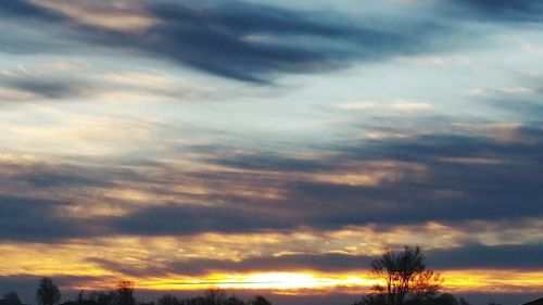 Low angle view of cloudy sky at sunset