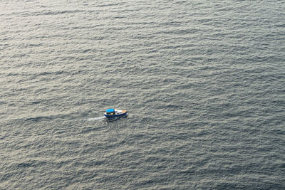 High angle view of people kayaking in sea