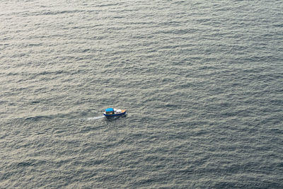 A small fishing motorboat in the middle of the sea. a fishing boat in the calm black sea