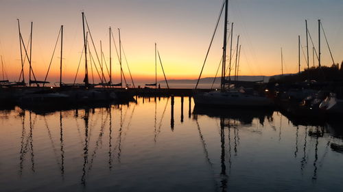 Sailboats in marina at sunset