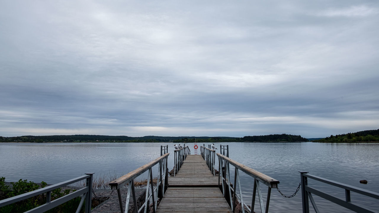 water, sky, cloud - sky, pier, beauty in nature, lake, tranquility, scenics - nature, the way forward, jetty, nature, wood - material, direction, day, tranquil scene, railing, built structure, architecture, non-urban scene, diminishing perspective, outdoors, no people, wood paneling