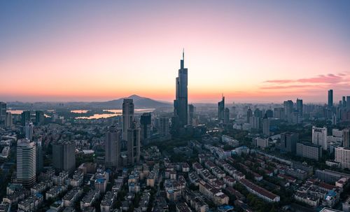 Aerial view of buildings in city during sunset