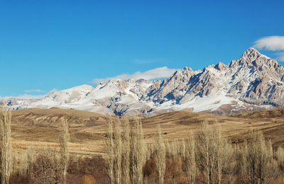 Scenic view of mountains against clear blue sky