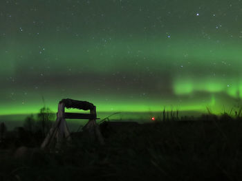 Scenic view of silhouette field against sky at night