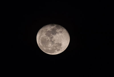 Low angle view of full moon against sky at night