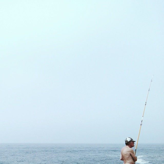 sea, water, horizon over water, copy space, men, clear sky, leisure activity, lifestyles, waterfront, rear view, nature, nautical vessel, tranquility, sky, tranquil scene, standing, scenics, day