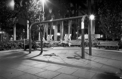 Illuminated street lights in park at night