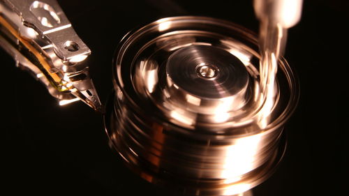 High angle view of illuminated electric lamp against black background